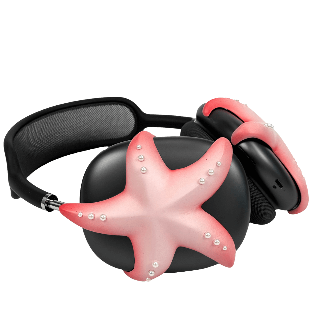 Apple over-ear headphones adorned with a metallic starfish sculpture and dot-like spheres, evoking constellations and marine elegance.