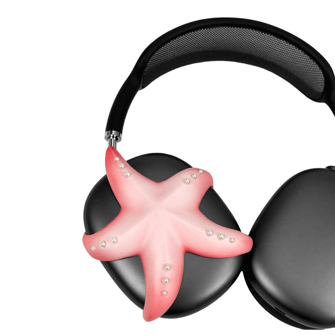 Apple over-ear headphones adorned with a metallic starfish sculpture and dot-like spheres, evoking constellations and marine elegance.