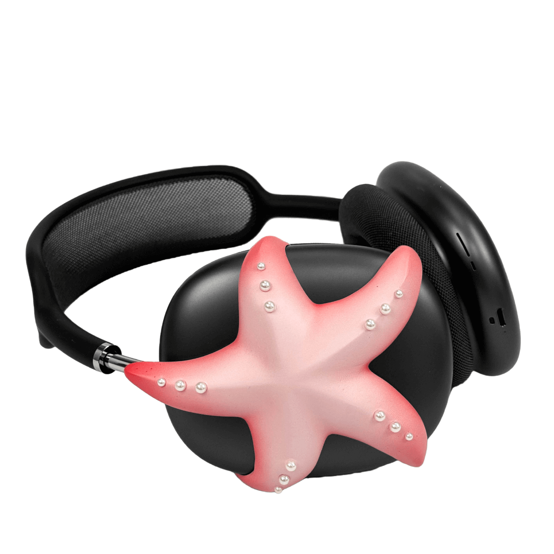 Apple over-ear headphones adorned with a metallic starfish sculpture and dot-like spheres, evoking constellations and marine elegance.