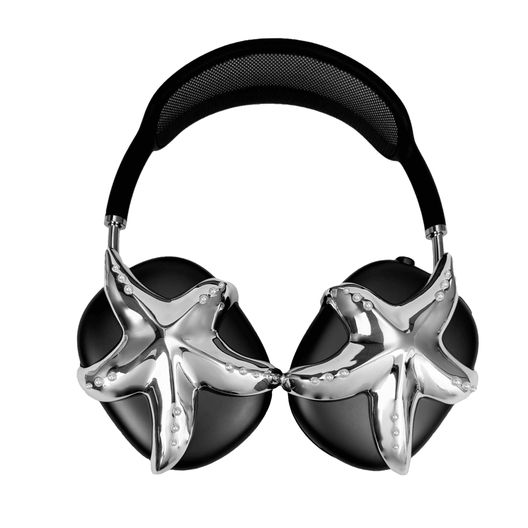 Apple over-ear headphones adorned with a metallic starfish sculpture and dot-like spheres, evoking constellations and marine elegance.