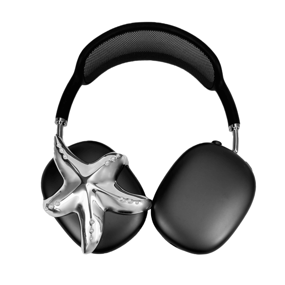Apple over-ear headphones adorned with a metallic starfish sculpture and dot-like spheres, evoking constellations and marine elegance.