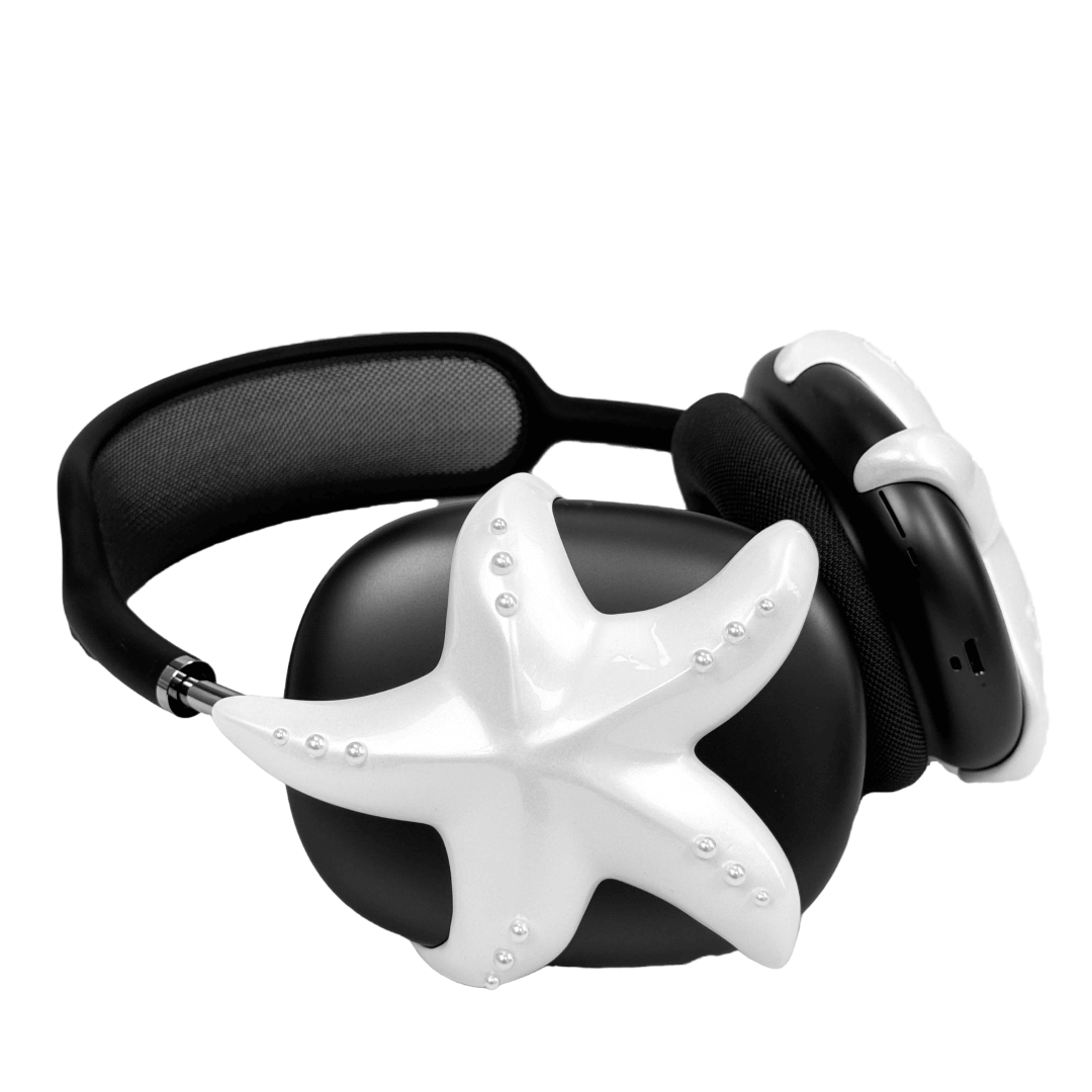 Apple over-ear headphones adorned with a metallic starfish sculpture and dot-like spheres, evoking constellations and marine elegance.