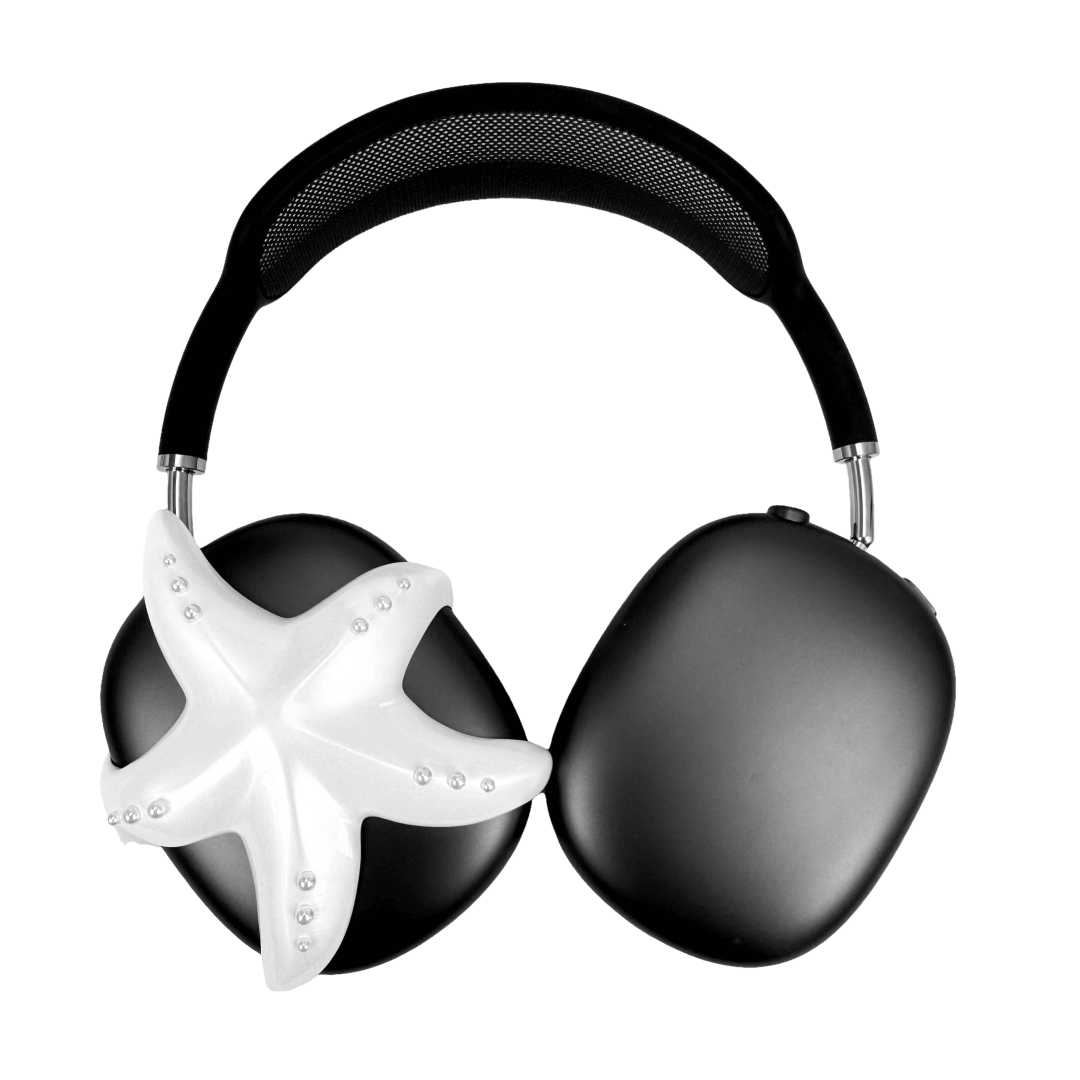 Apple over-ear headphones adorned with a metallic starfish sculpture and dot-like spheres, evoking constellations and marine elegance.