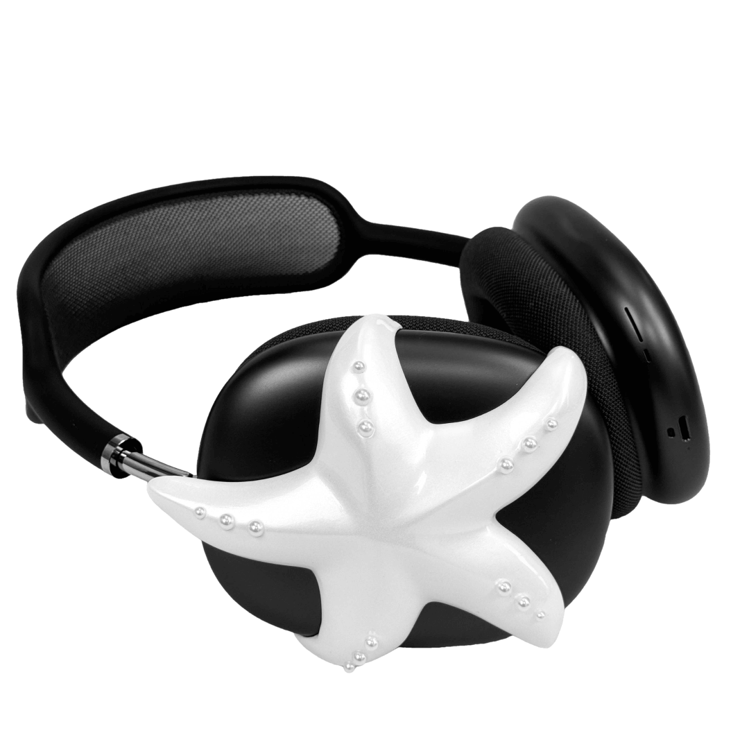 Apple over-ear headphones adorned with a metallic starfish sculpture and dot-like spheres, evoking constellations and marine elegance.