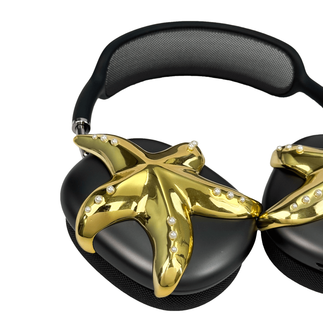 Apple over-ear headphones adorned with a metallic starfish sculpture and dot-like spheres, evoking constellations and marine elegance.