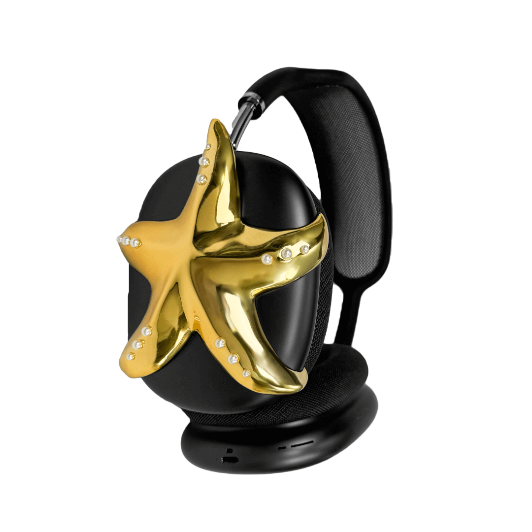 Apple over-ear headphones adorned with a metallic starfish sculpture and dot-like spheres, evoking constellations and marine elegance.