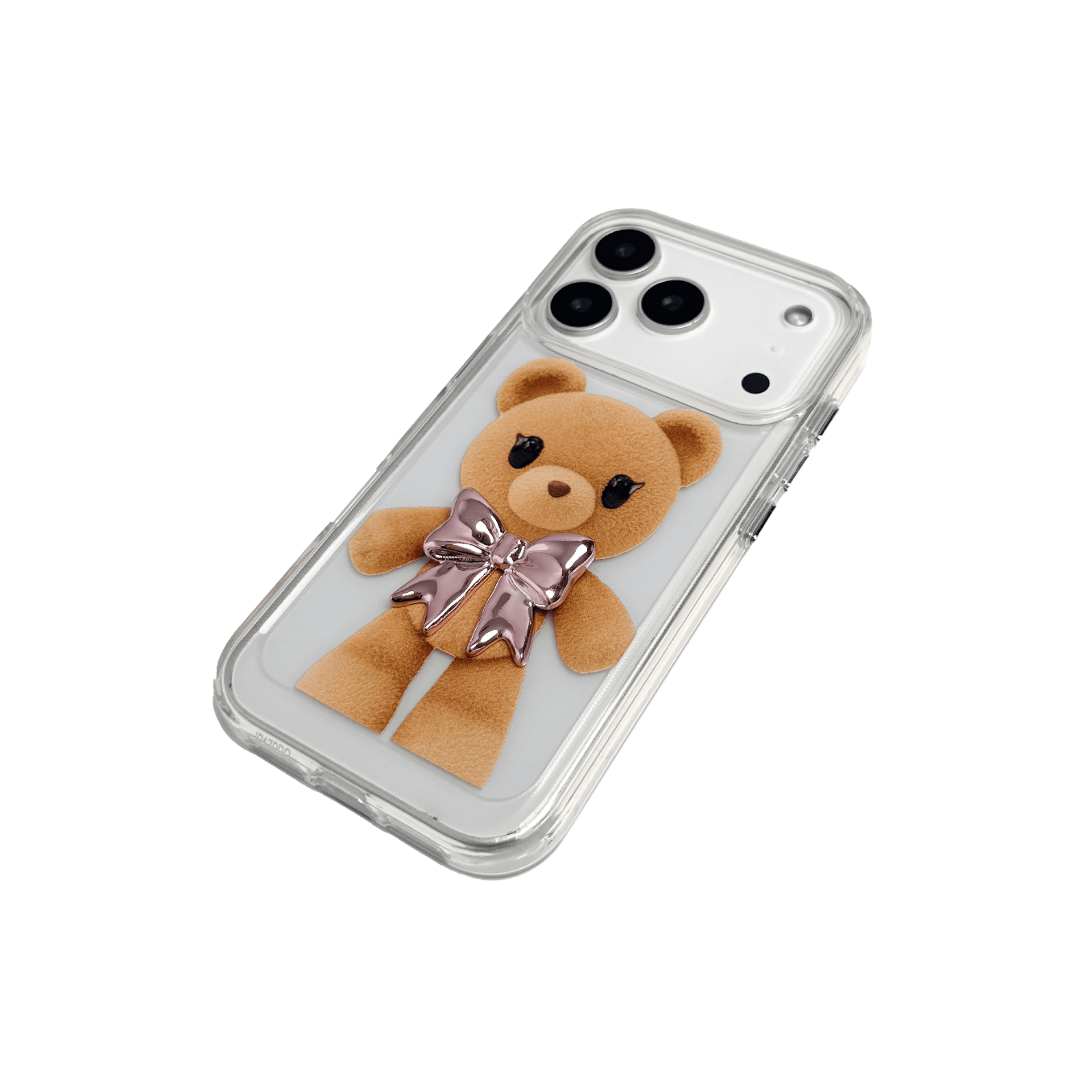 A clear iPhone case featuring an illustration of a standing brown teddy bear wearing a pink metallic bow tie. The case is transparent, allowing the phone's color to show through.