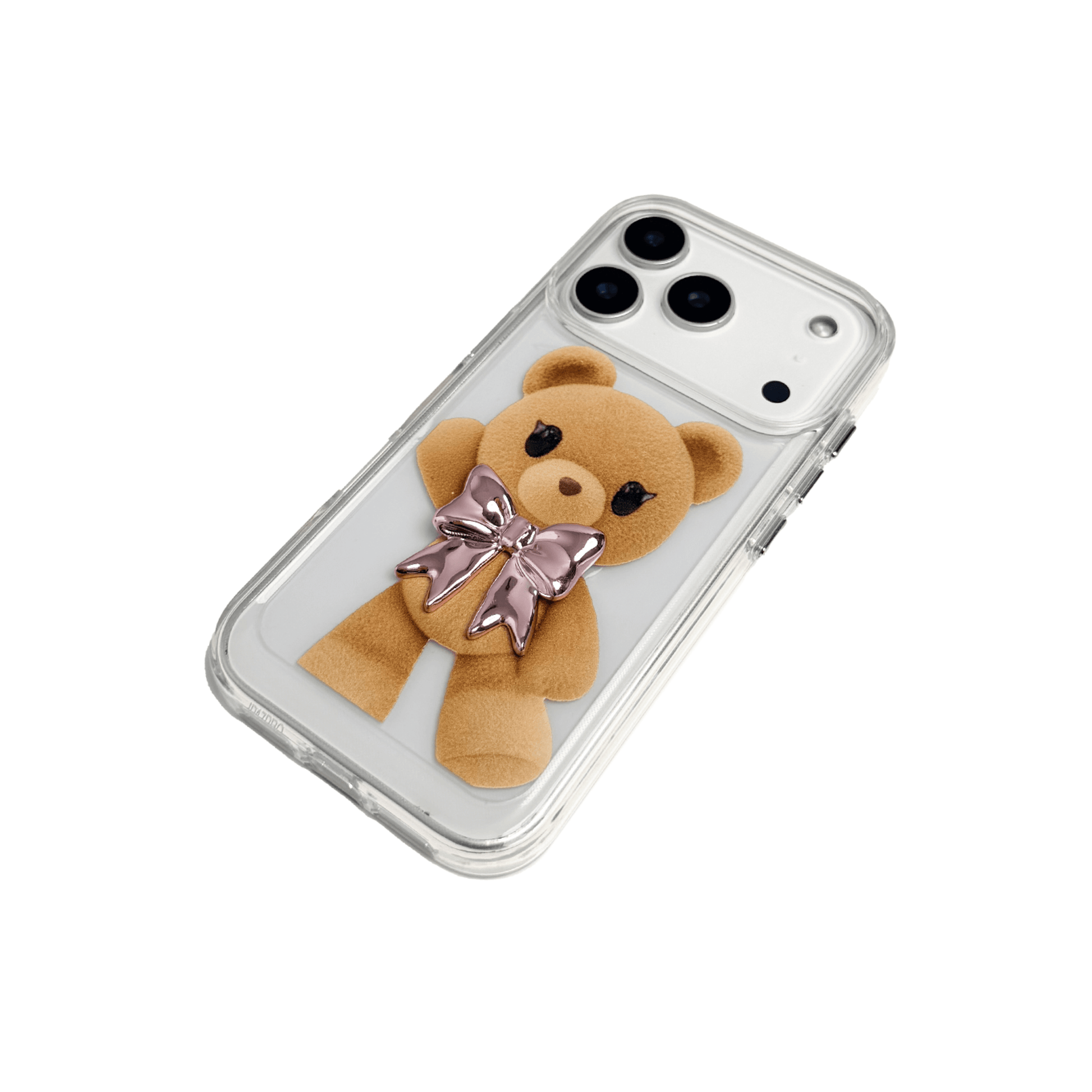 A clear iPhone case featuring an illustration of a standing brown teddy bear wearing a pink metallic bow tie. The case is transparent, allowing the phone's color to show through.