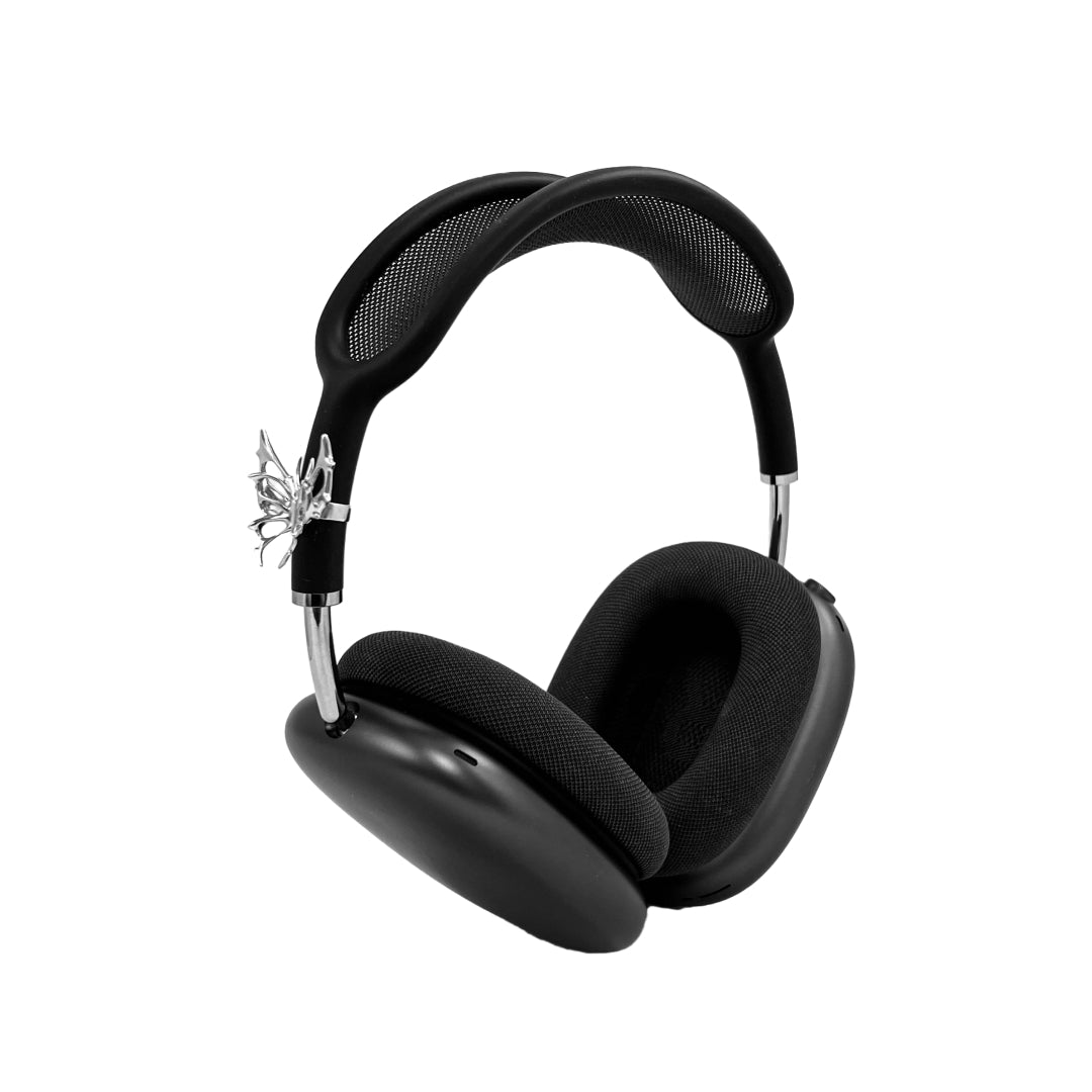 Chrome thorned butterfly-shaped accessory clipped onto AirPods Max.