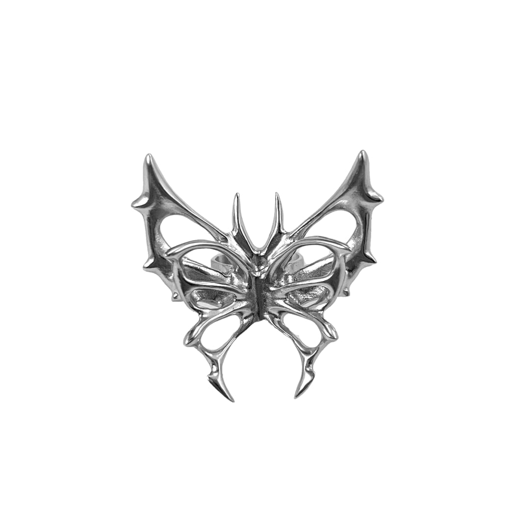 Chrome thorned butterfly-shaped accessory clipped onto AirPods Max.