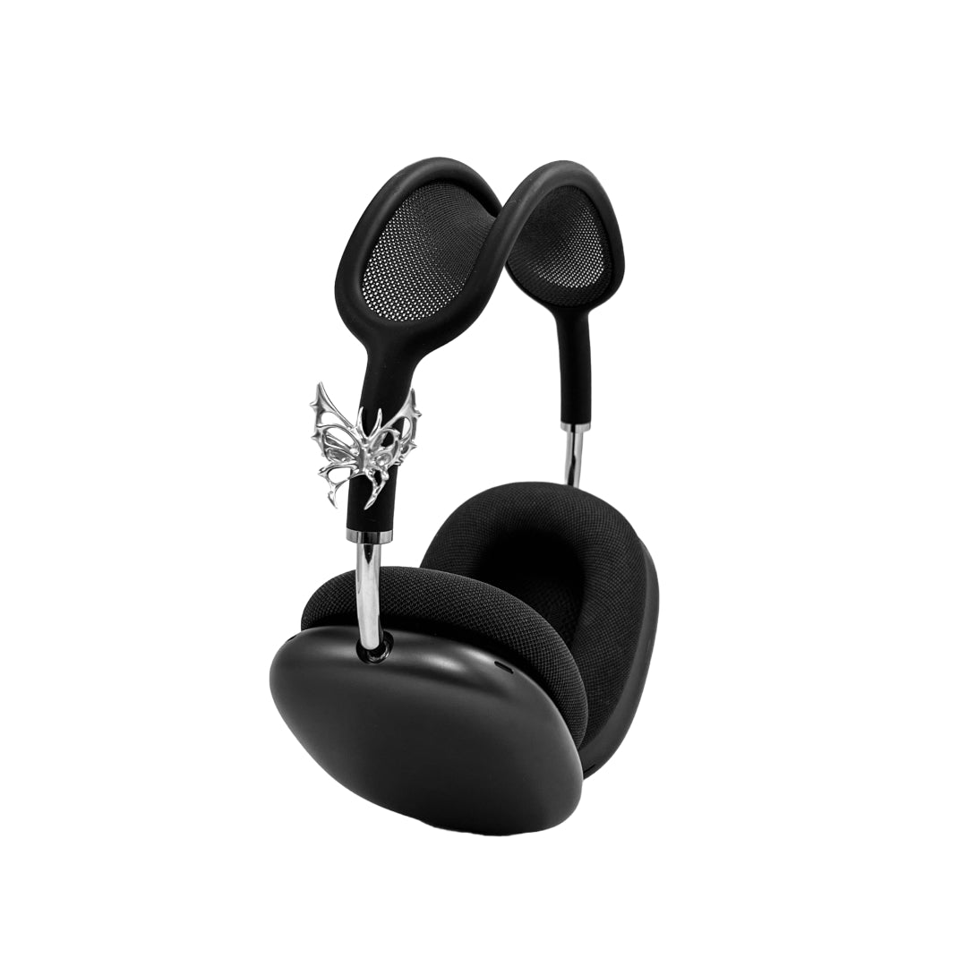 Chrome thorned butterfly-shaped accessory clipped onto AirPods Max.