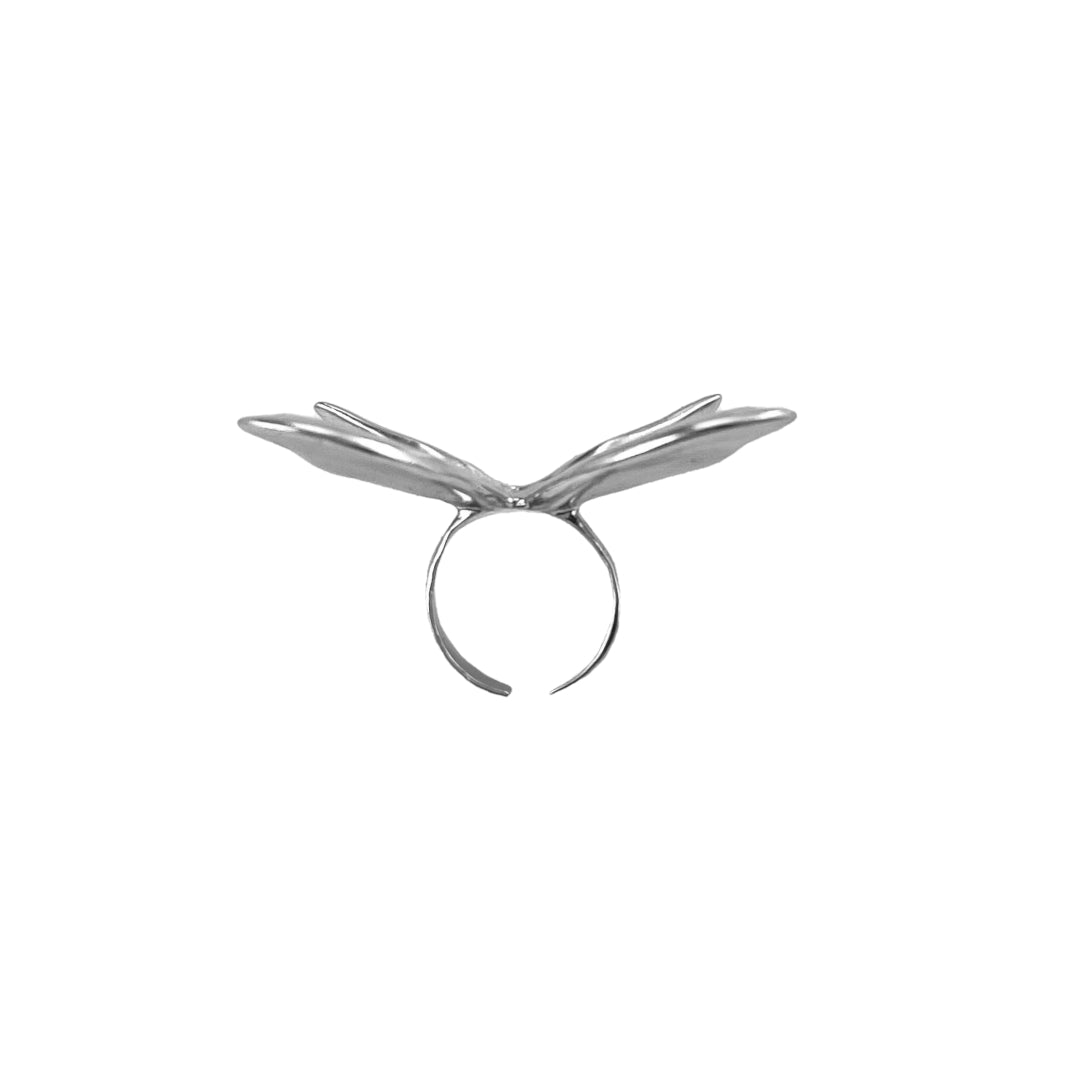 Chrome butterfly-shaped decorative accessory attached to AirPods Max.