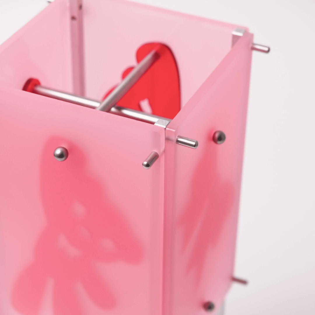 Pink transparent object with metal bars on a white background