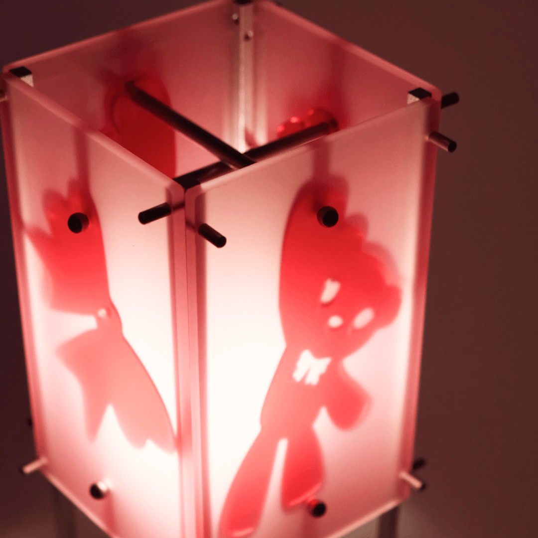 Red lantern with cut-out shapes on a dark background