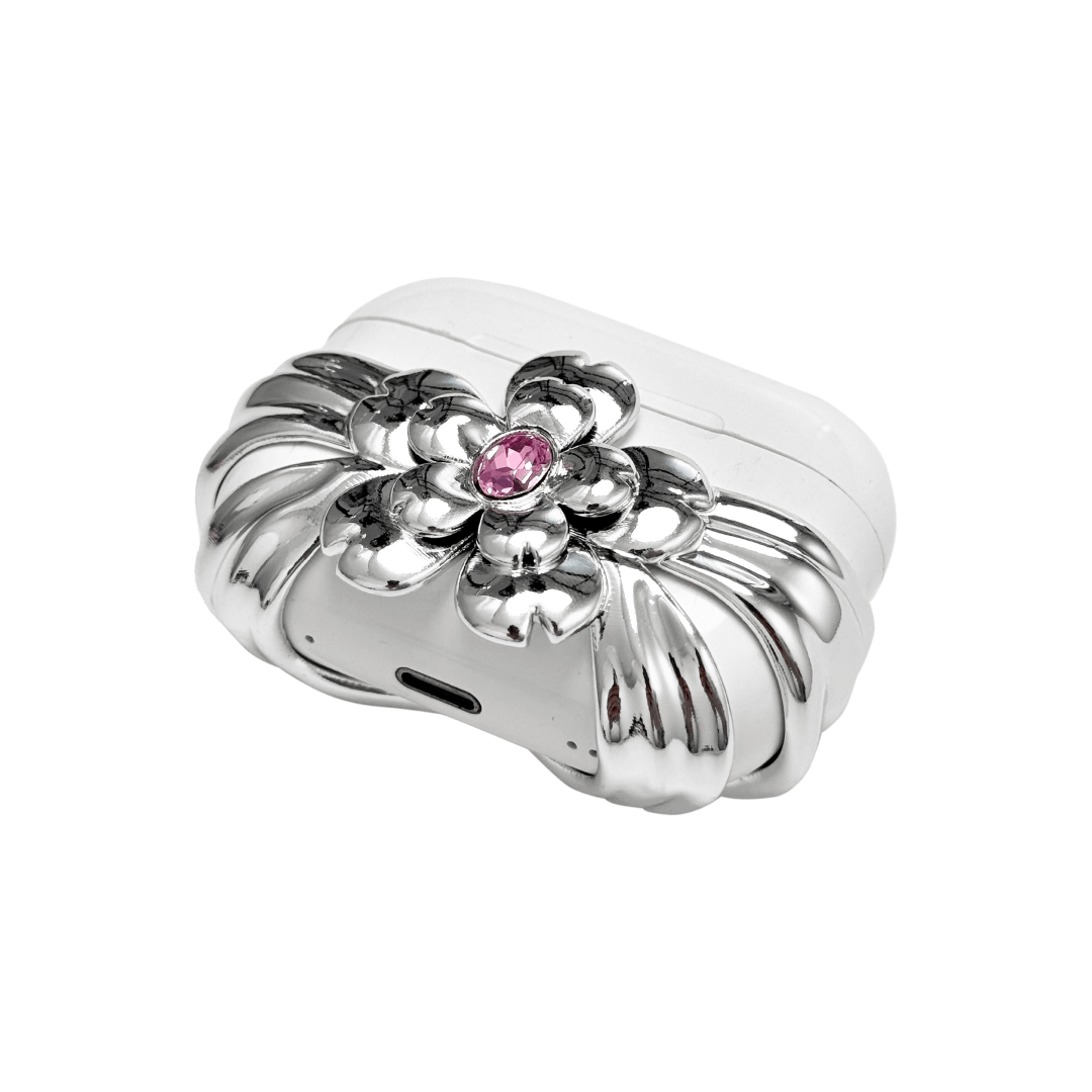 AirPods case cover with a multi-petal cherry blossom design in pink or silver, featuring a sparkling pink Swarovski crystal at the flower’s center for a refined, elegant touch.