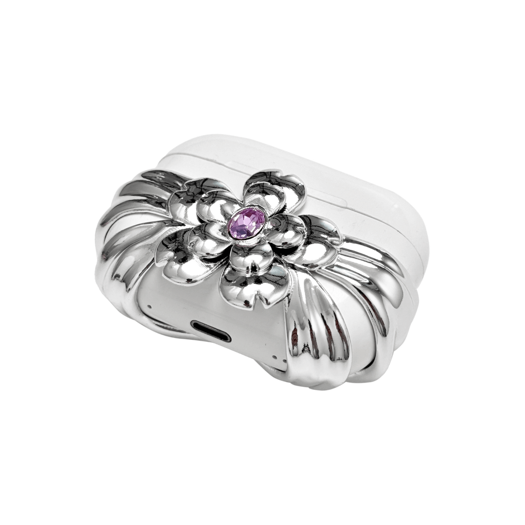 AirPods case cover with a multi-petal cherry blossom design in pink or silver, featuring a sparkling pink Swarovski crystal at the flower’s center for a refined, elegant touch.