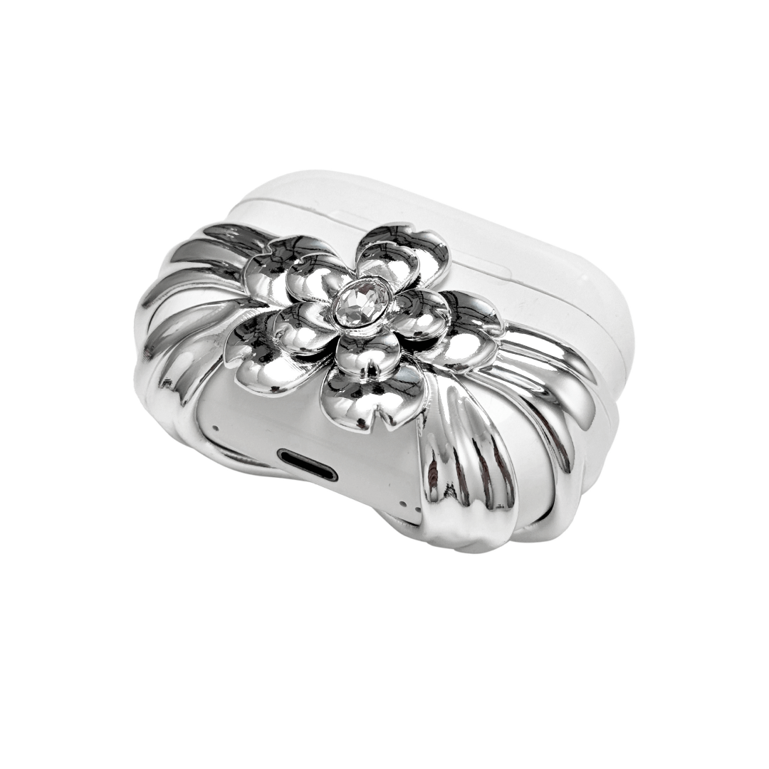 AirPods case cover with a multi-petal cherry blossom design in pink or silver, featuring a sparkling pink Swarovski crystal at the flower’s center for a refined, elegant touch.