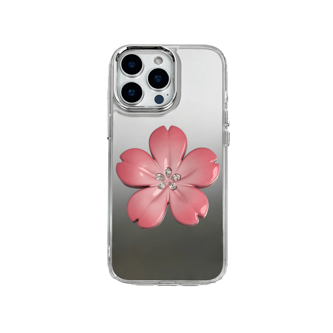 Silver mirror-finish iPhone case decorated with a cherry blossom flower in pink and silver tones, accented by five sparkling crystals for an elegant, luxurious look.