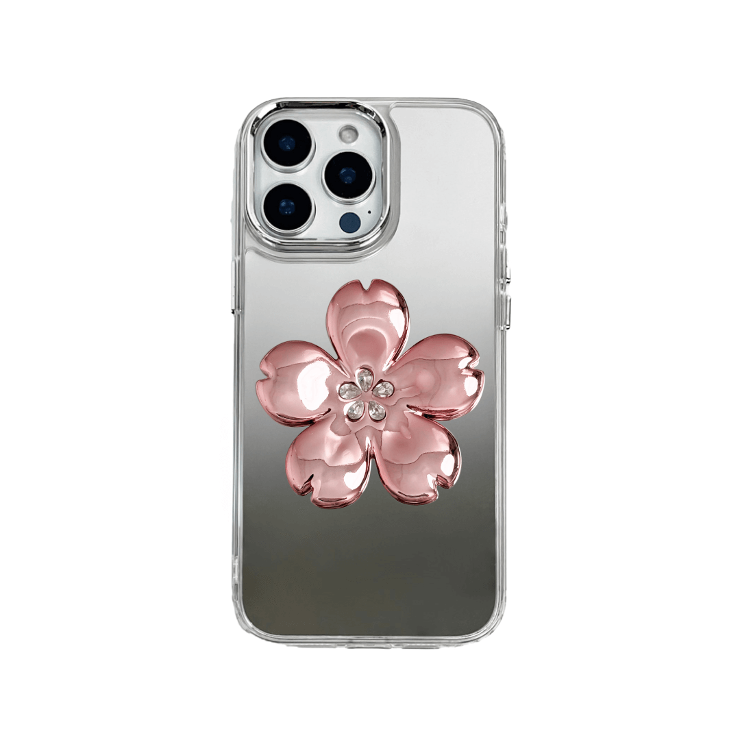 Silver mirror-finish iPhone case decorated with a cherry blossom flower in pink and silver tones, accented by five sparkling crystals for an elegant, luxurious look.