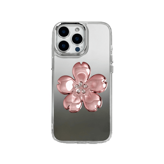 Silver mirror-finish iPhone case decorated with a cherry blossom flower in pink and silver tones, accented by five sparkling crystals for an elegant, luxurious look.