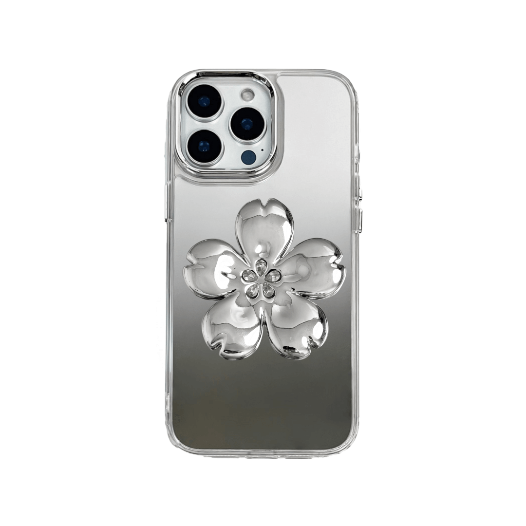Silver mirror-finish iPhone case decorated with a cherry blossom flower in pink and silver tones, accented by five sparkling crystals for an elegant, luxurious look.