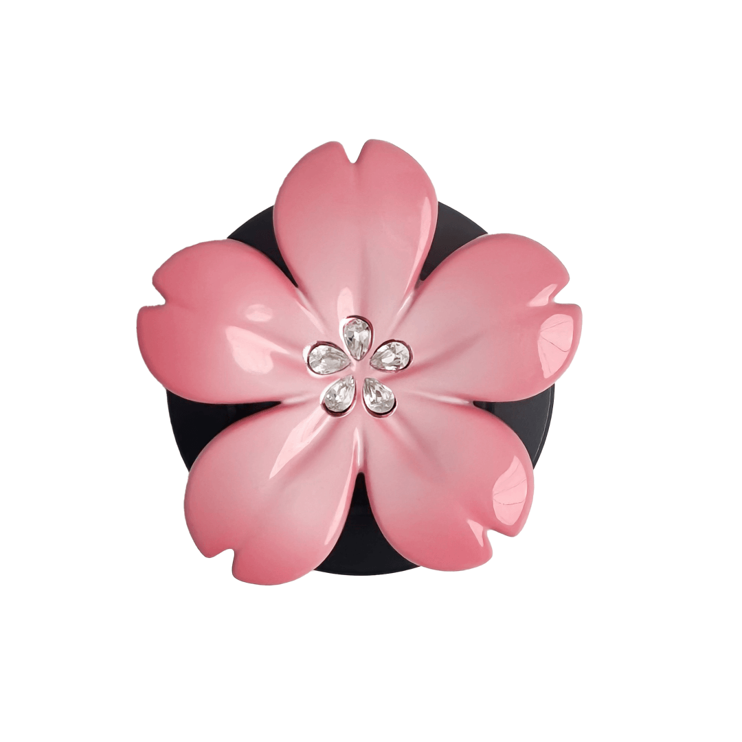 Magnetic phone grip with a silver mirror finish, decorated with a cherry blossom in pink or silver tones accented by five sparkling crystals for a luxurious, floral-inspired look.