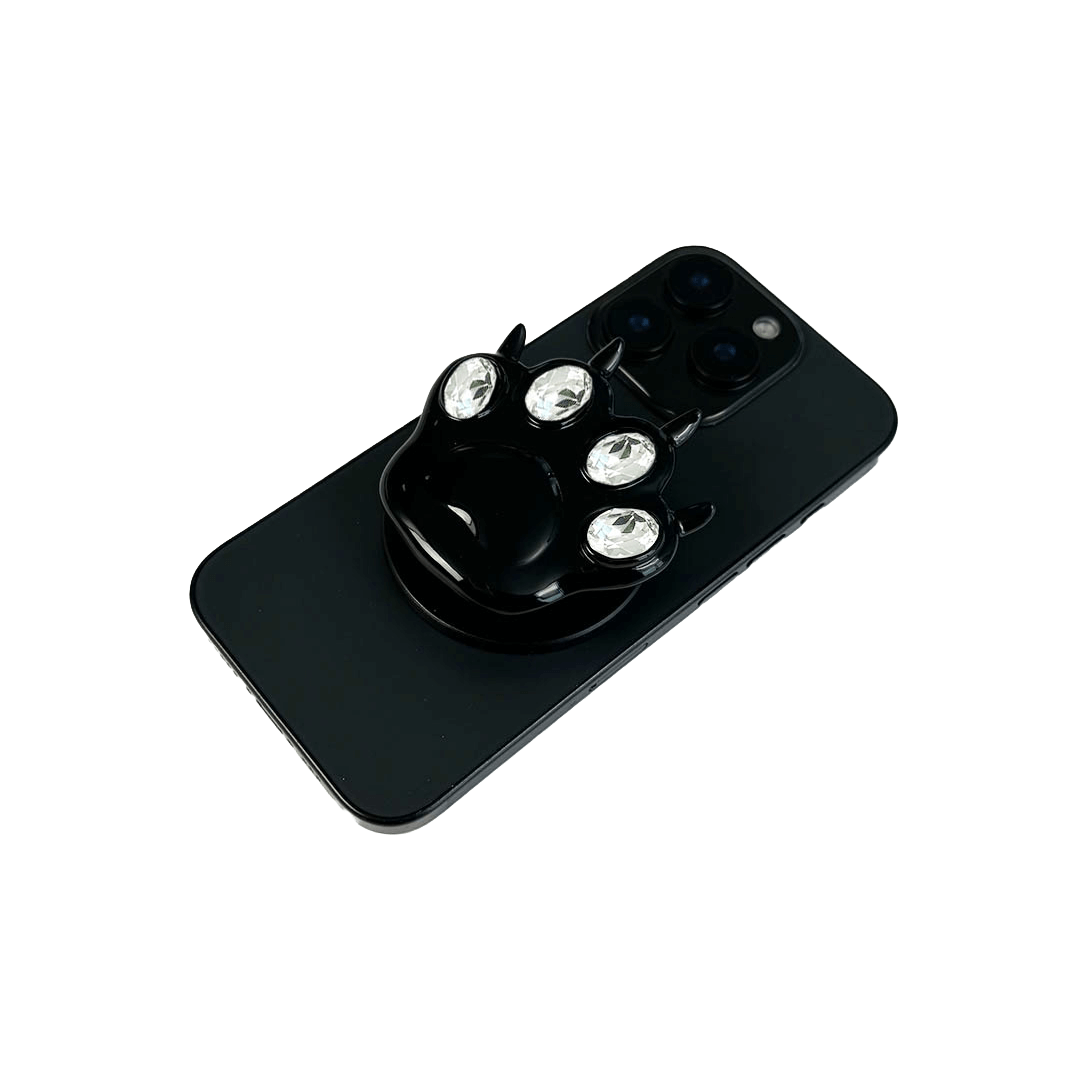 GEM CAT PAW phone grip with black or silver cat paw design, adorned with Swarovski crystals in black, white, or pink.