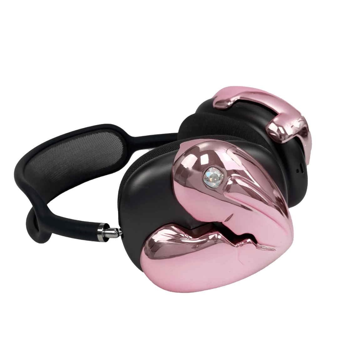 Silver, pink, red and black AirPods Max cover featuring a metallic broken heart design, with a sculpted crack down the center and small embedded crystal detail.