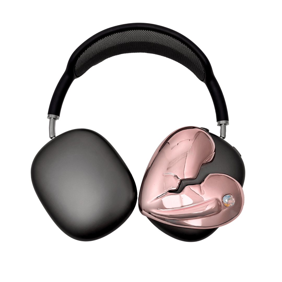 Silver, pink, red and black AirPods Max cover featuring a metallic broken heart design, with a sculpted crack down the center and small embedded crystal detail.