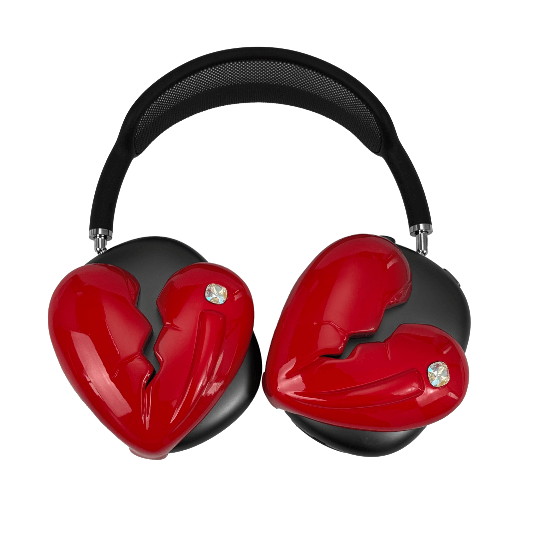 Silver, pink, red and black AirPods Max cover featuring a metallic broken heart design, with a sculpted crack down the center and small embedded crystal detail.