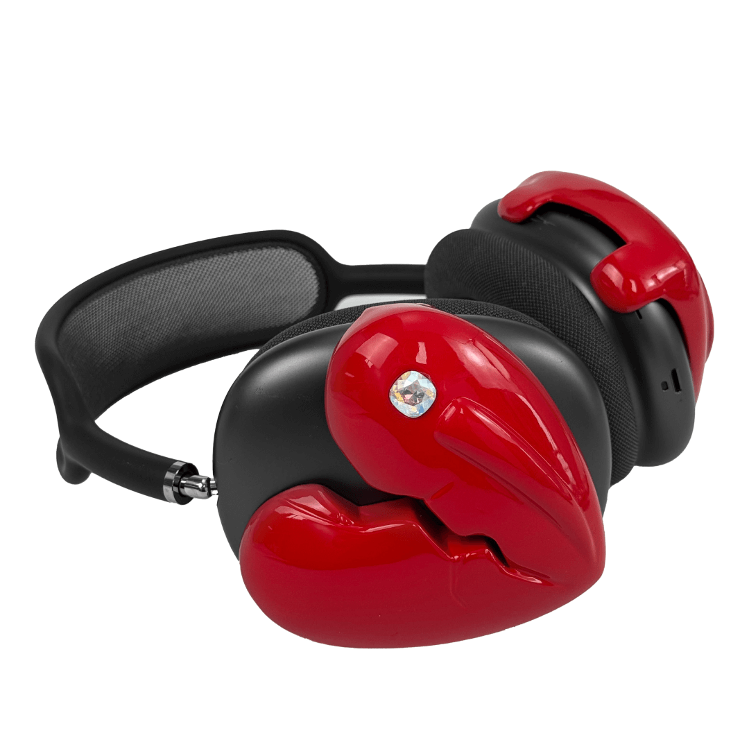 Silver, pink, red and black AirPods Max cover featuring a metallic broken heart design, with a sculpted crack down the center and small embedded crystal detail.