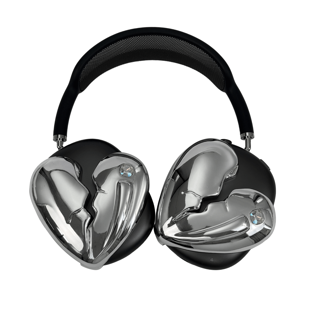 Silver, pink, red and black AirPods Max cover featuring a metallic broken heart design, with a sculpted crack down the center and small embedded crystal detail.