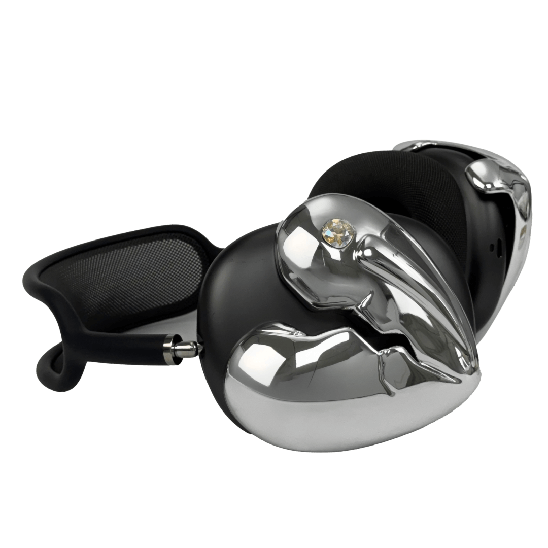 Silver, pink, red and black AirPods Max cover featuring a metallic broken heart design, with a sculpted crack down the center and small embedded crystal detail.
