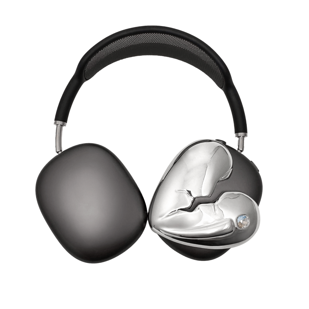 Silver, pink, red and black AirPods Max cover featuring a metallic broken heart design, with a sculpted crack down the center and small embedded crystal detail.