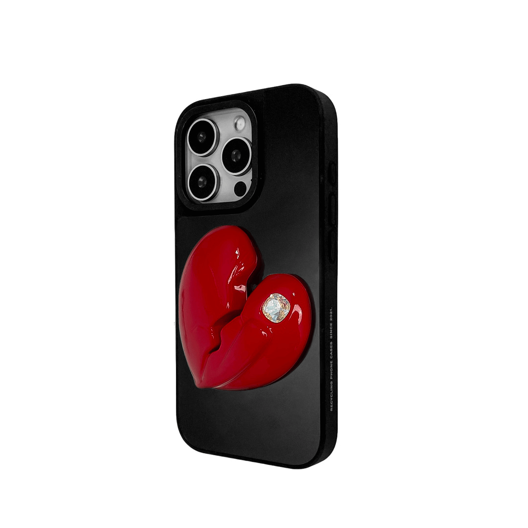 3D silver, pink, red and black metallic iPhone case featuring a cracked heart design with smooth chrome finish and a single embedded gem.