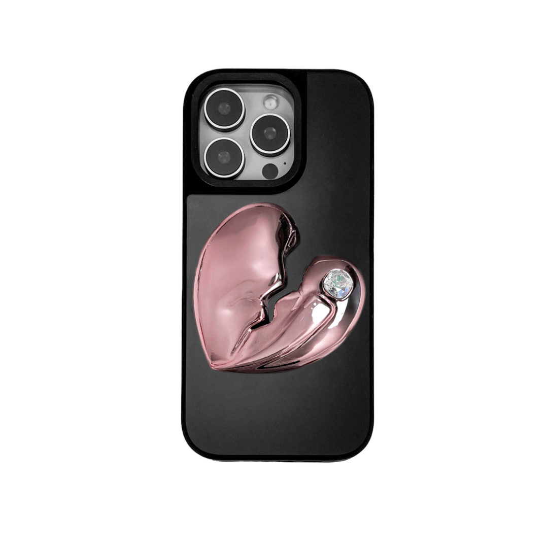3D silver, pink, red and black metallic iPhone case featuring a cracked heart design with smooth chrome finish and a single embedded gem.