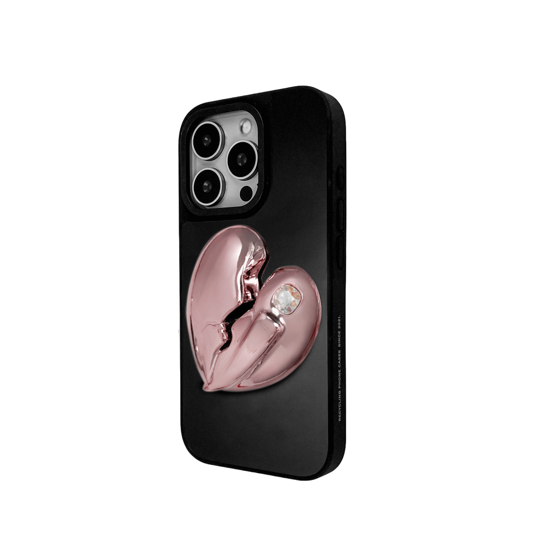 3D silver, pink, red and black metallic iPhone case featuring a cracked heart design with smooth chrome finish and a single embedded gem.
