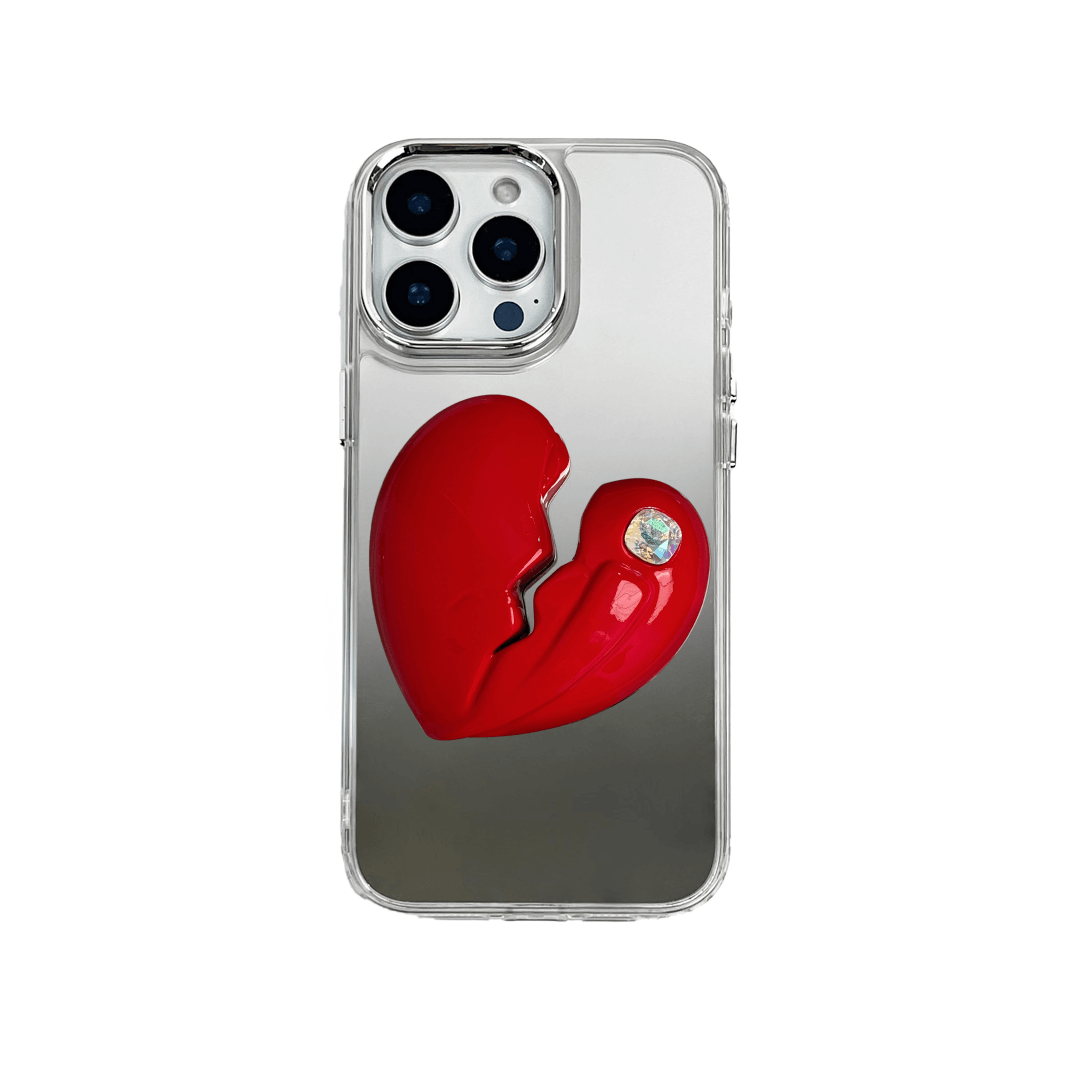 3D silver, pink, red and black metallic iPhone case featuring a cracked heart design with smooth chrome finish and a single embedded gem.