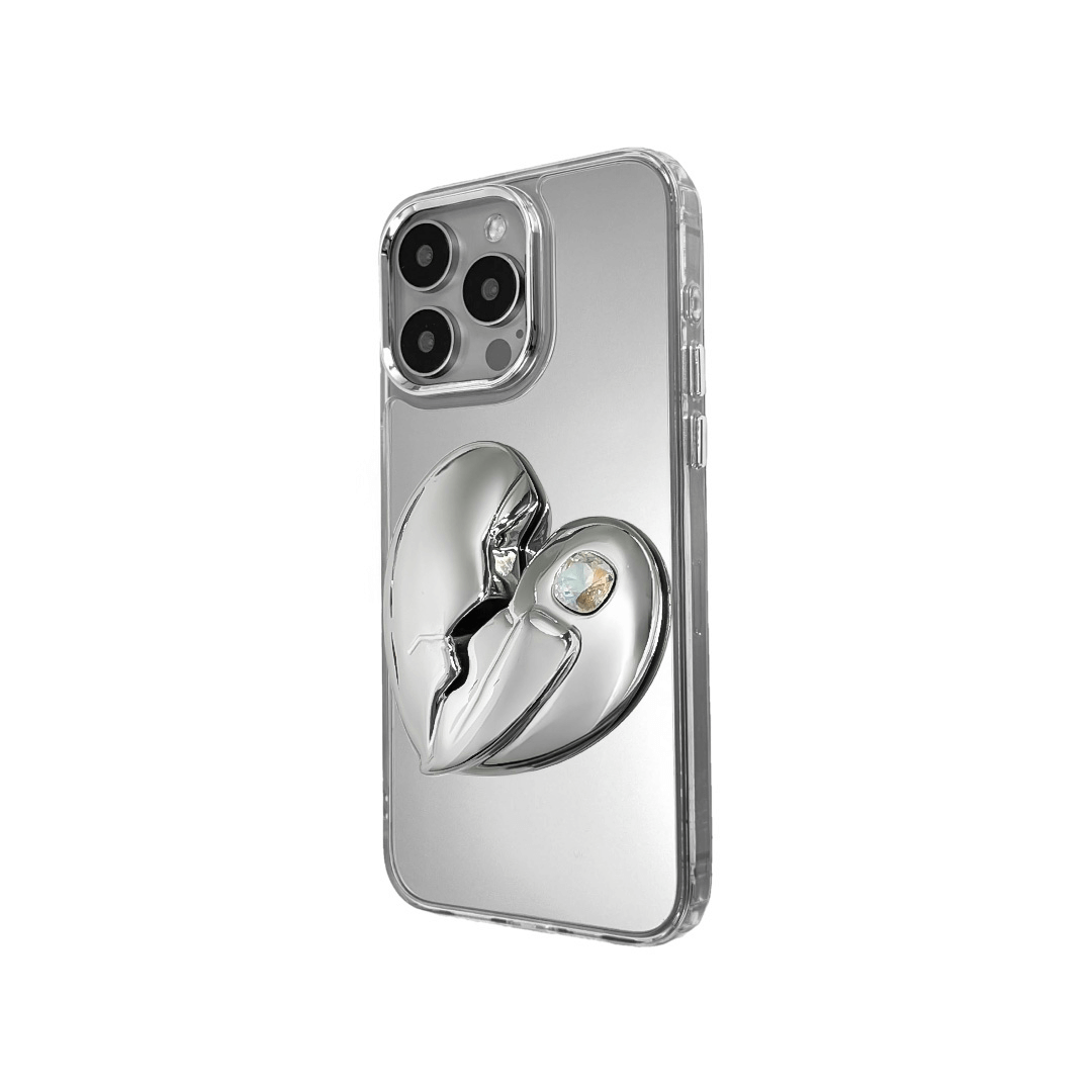 3D silver, pink, red and black metallic iPhone case featuring a cracked heart design with smooth chrome finish and a single embedded gem.