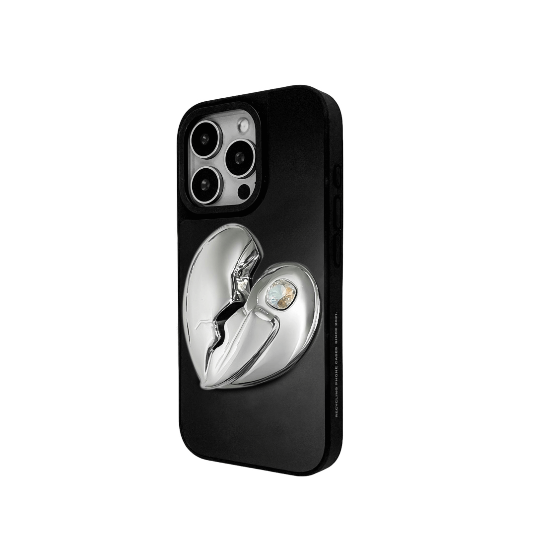 3D silver, pink, red and black metallic iPhone case featuring a cracked heart design with smooth chrome finish and a single embedded gem.