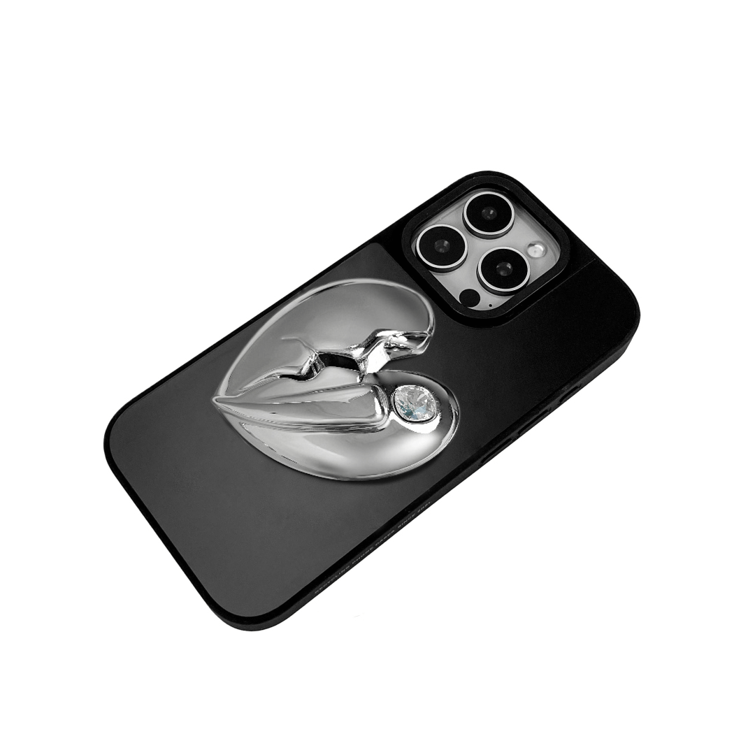 3D silver, pink, red and black metallic iPhone case featuring a cracked heart design with smooth chrome finish and a single embedded gem.