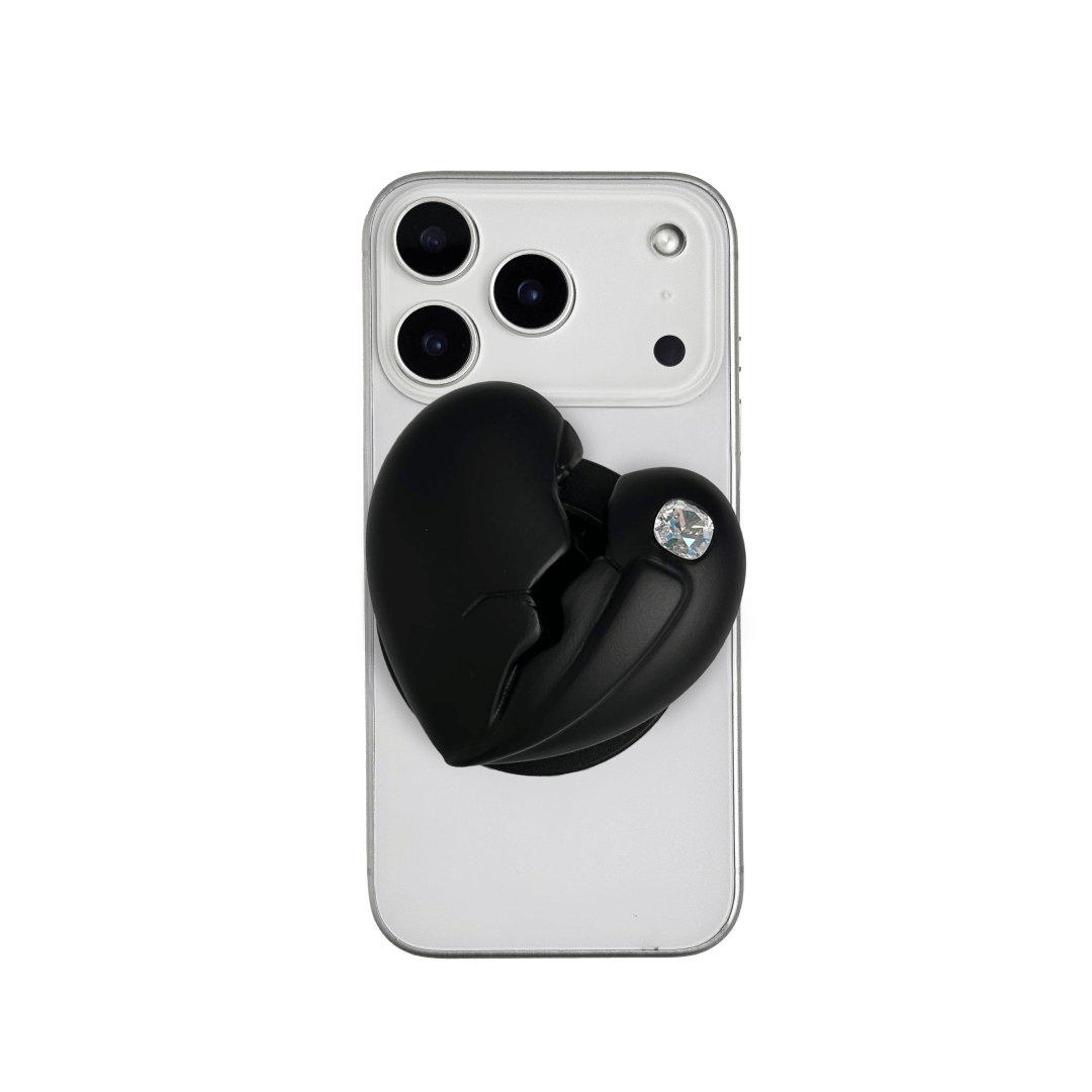 3D silver, pink, red and black metallic Phone grip featuring a cracked heart design with smooth chrome finish and a single embedded gem.