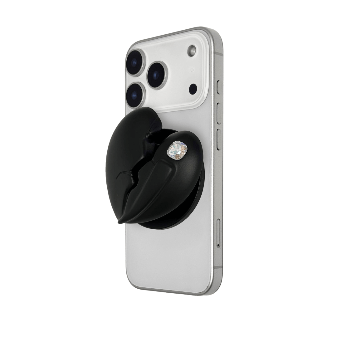 3D silver, pink, red and black metallic Phone grip featuring a cracked heart design with smooth chrome finish and a single embedded gem.