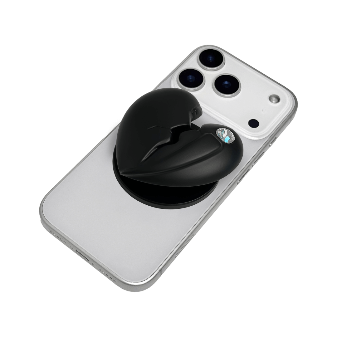 3D silver, pink, red and black metallic Phone grip featuring a cracked heart design with smooth chrome finish and a single embedded gem.