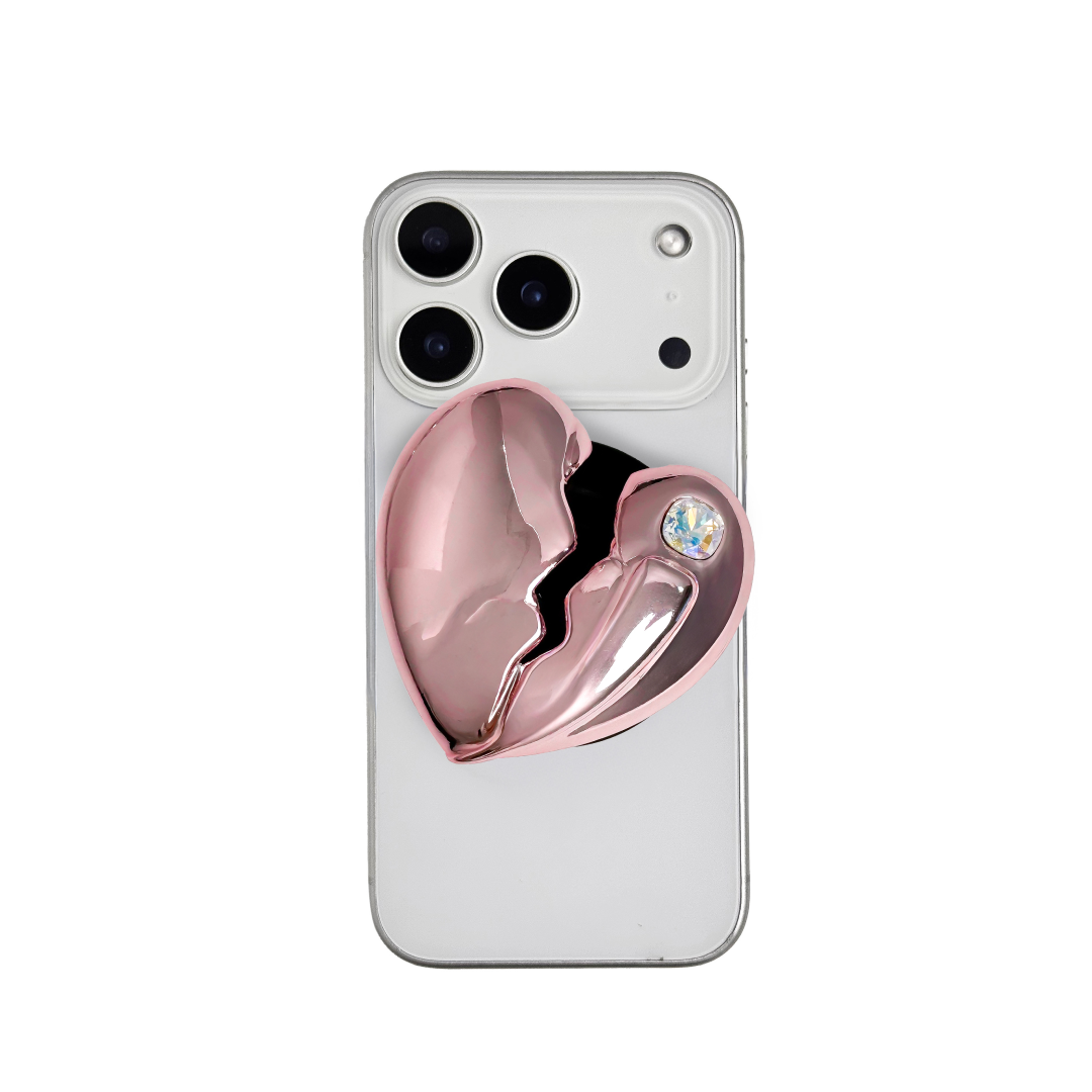 3D silver, pink, red and black metallic Phone grip featuring a cracked heart design with smooth chrome finish and a single embedded gem.