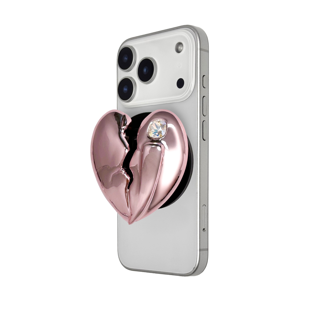 3D silver, pink, red and black metallic Phone grip featuring a cracked heart design with smooth chrome finish and a single embedded gem.