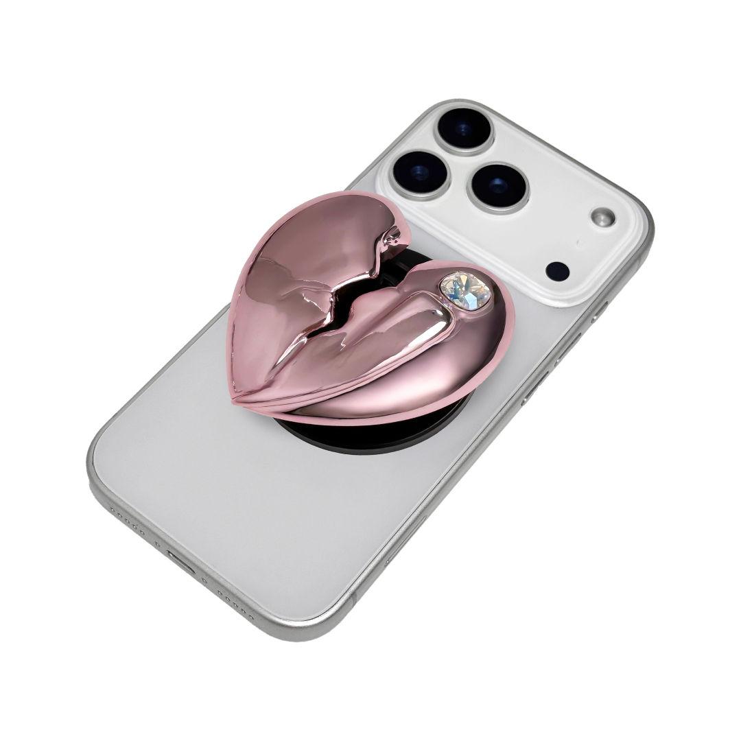 3D silver, pink, red and black metallic Phone grip featuring a cracked heart design with smooth chrome finish and a single embedded gem.