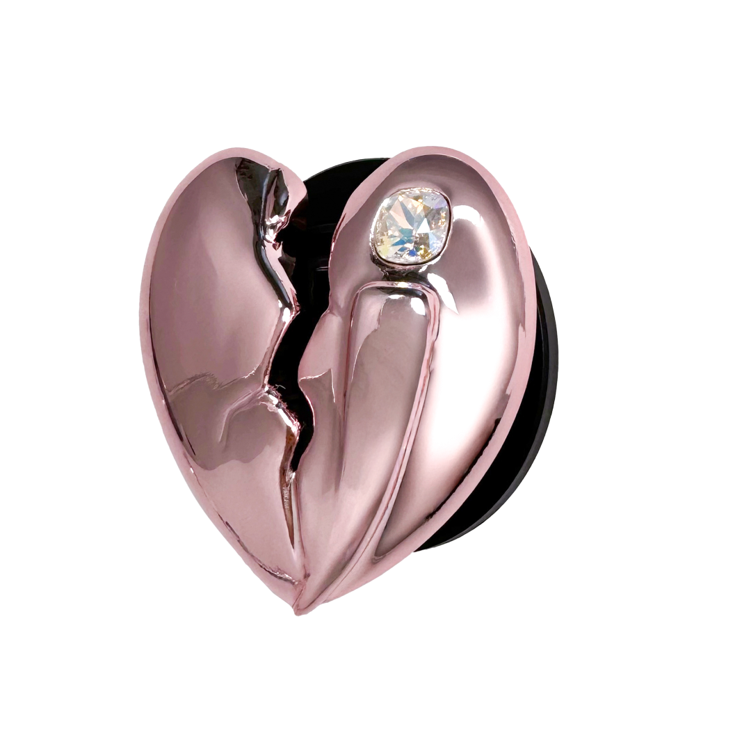 3D silver, pink, red and black metallic Phone grip featuring a cracked heart design with smooth chrome finish and a single embedded gem.
