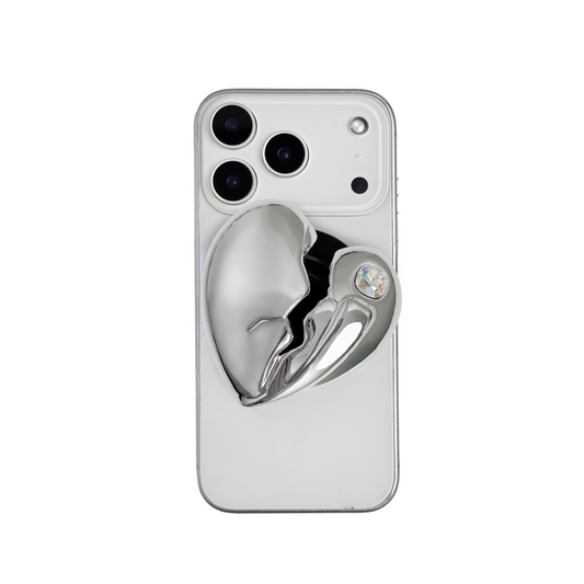 3D silver, pink, red and black metallic Phone grip featuring a cracked heart design with smooth chrome finish and a single embedded gem.