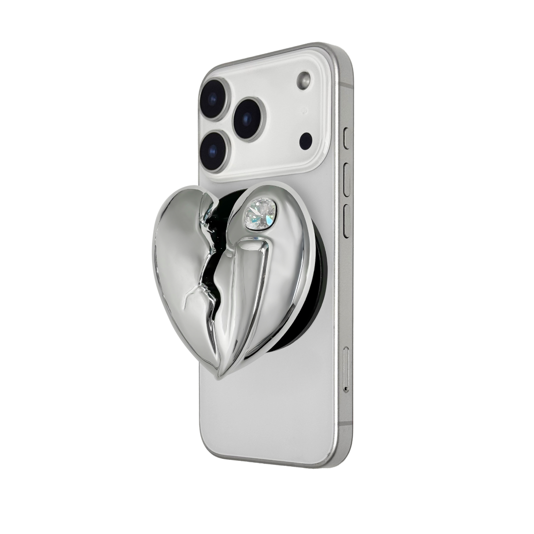 3D silver, pink, red and black metallic Phone grip featuring a cracked heart design with smooth chrome finish and a single embedded gem.